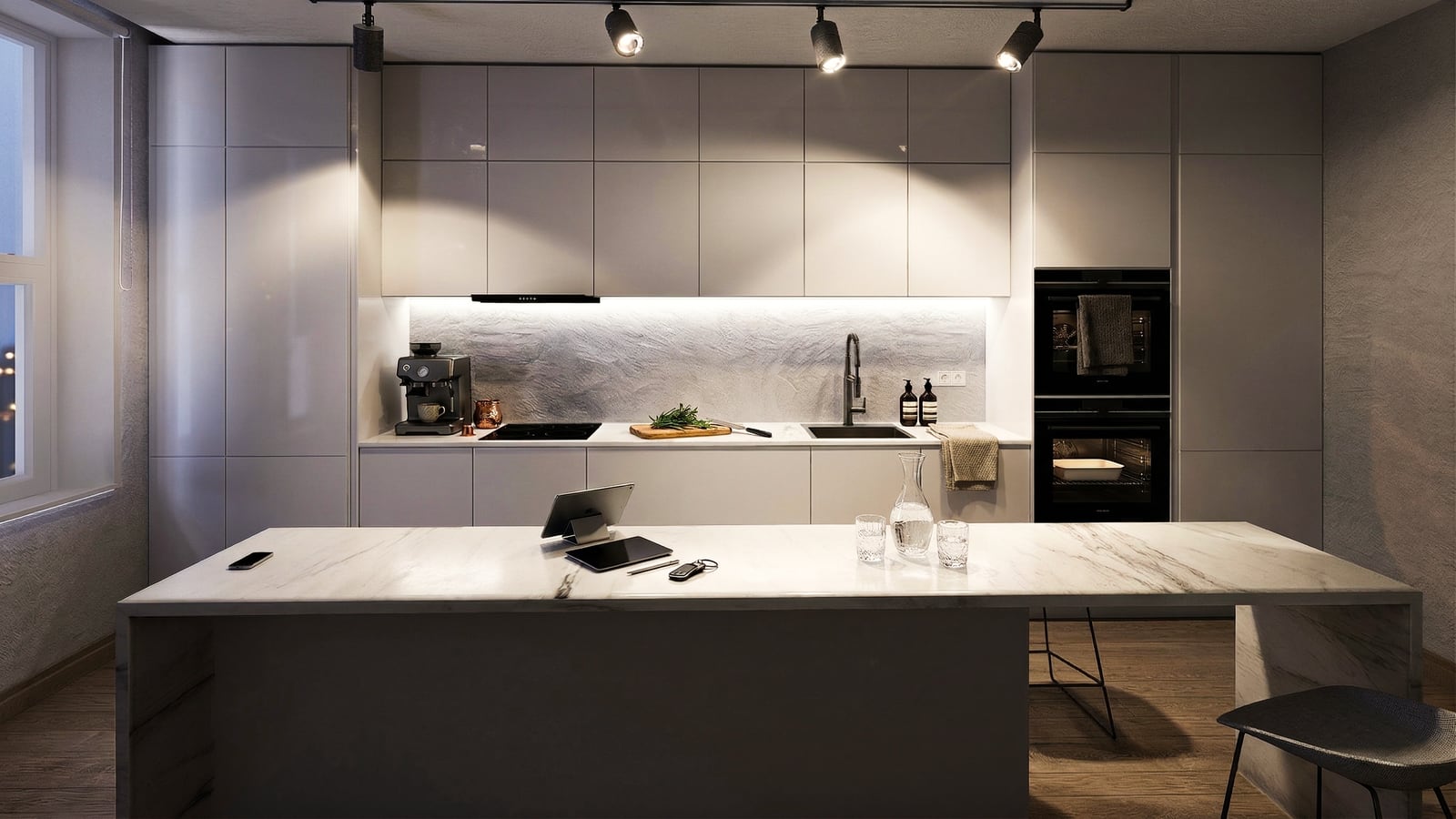 Kitchen with a marble island and track lighting